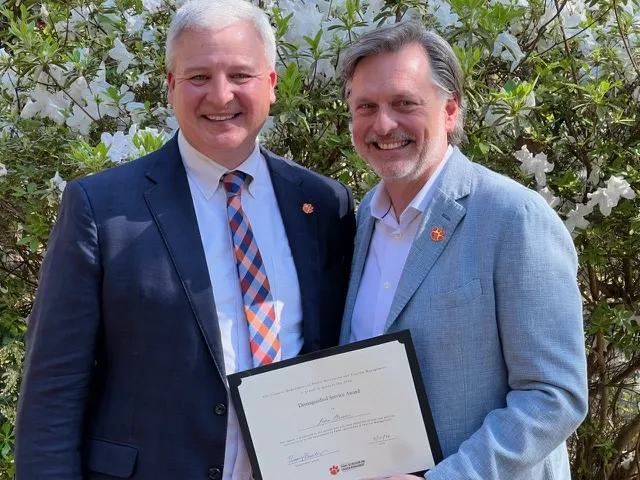 LEO Principal Kevin Brewer receives Distinguished Service Award from Bob Barcelona, Department Chair/Head Professor of The Department of Parks, Recreation, and Tourism Management in the College of Behavioral, Social and Health Sciences as Clemson University.